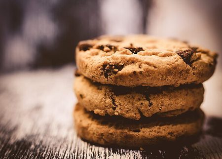 Three stacked chocolate chip cookies
